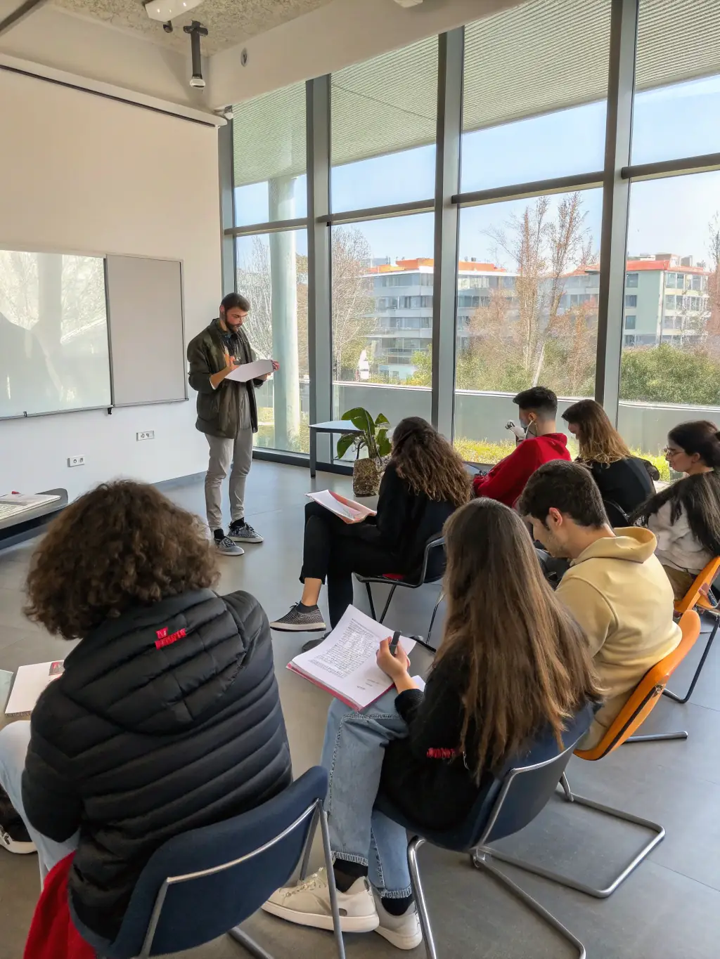 A group of young people learning film-making techniques during an audiovisual media workshop, empowering them to express their creativity and document their experiences.